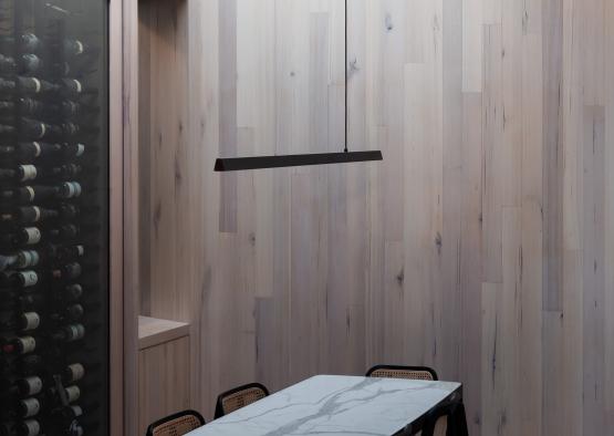 a table and chairs in a room with a wine rack