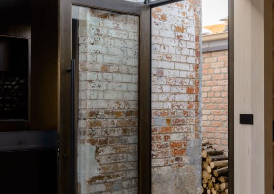 a glass door in a brick wall