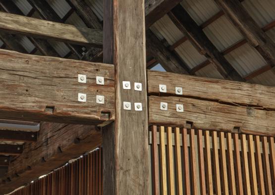 a wooden structure with metal bolts