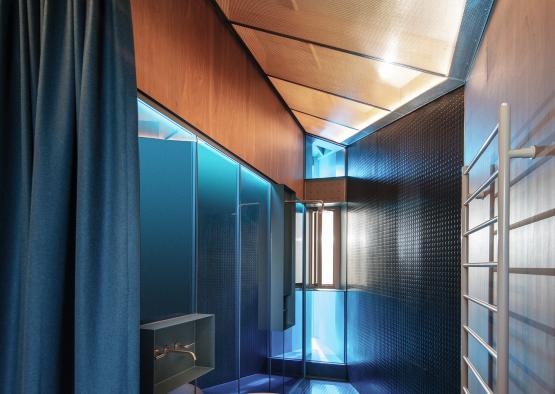 a bathroom with a blue curtain and a bathtub
