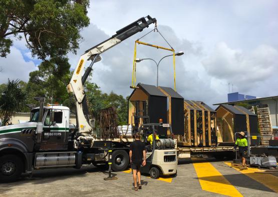a crane lifting a house