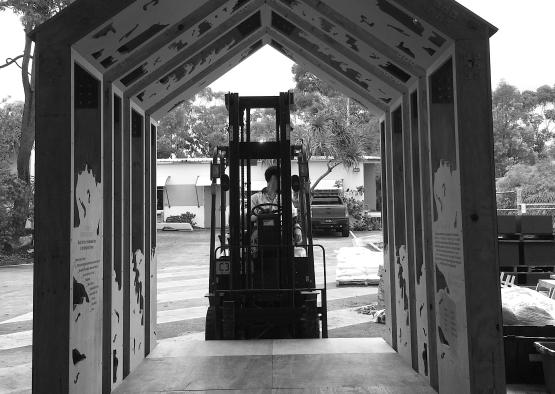 a wooden structure with a forklift behind it