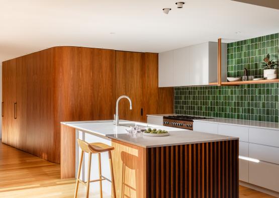 a kitchen with a sink and stools