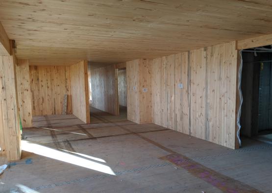 a room with wood walls and a ceiling