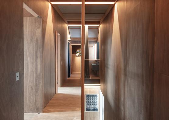 a hallway with a wooden wall and a light fixture