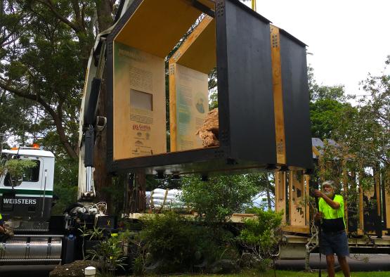 a man standing next to a large black box