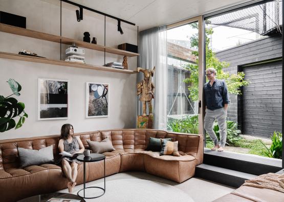 a man and woman sitting on a couch in a living room