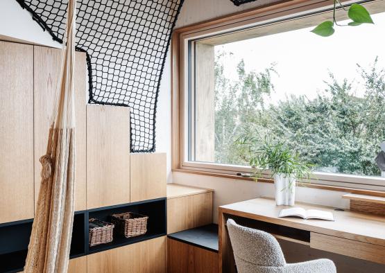 a room with a desk and a hammock