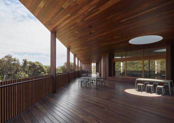 a wooden deck with tables and chairs