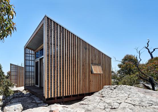 a small wooden building on a rocky surface