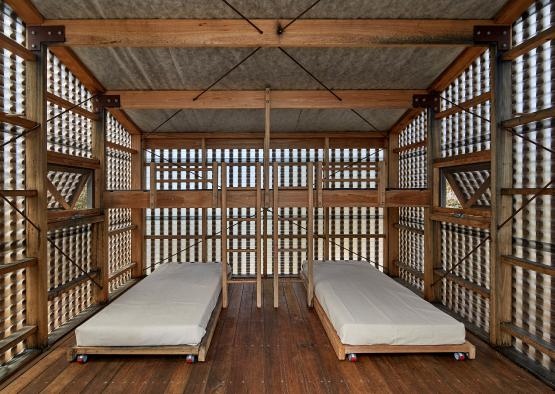 two beds inside a wooden structure