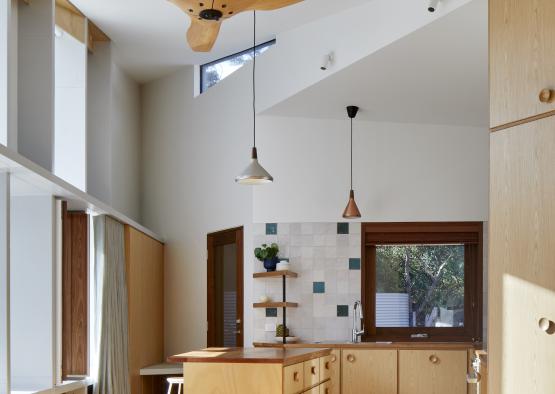 a kitchen with a ceiling fan and a counter