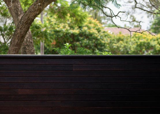 a wood fence with trees in the background