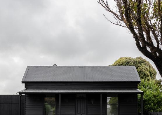 a house with a fence and a tree