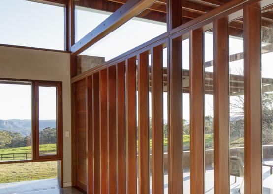 a room with wood beams and a patio