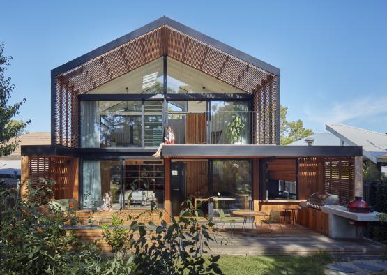 a house with a patio and a couple of people sitting on the porch