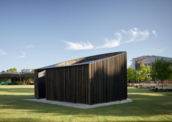 a building in a grassy area