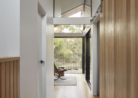 a hallway with a wood floor and a wood floor and a wood floor