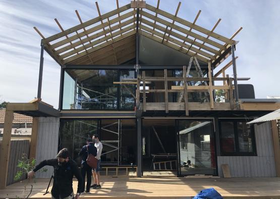 a building under construction with people standing on a deck