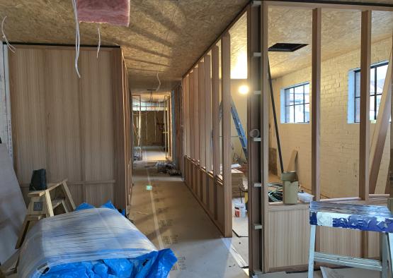 a hallway with wood walls and a ladder