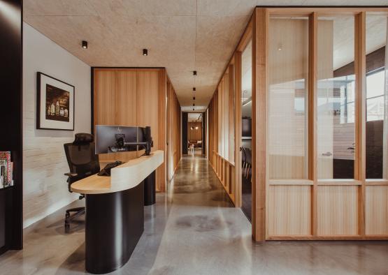 a hallway with a desk and a computer