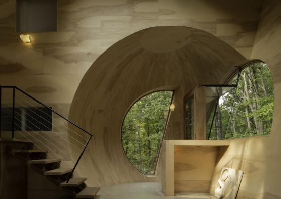 a room with a circular window and stairs