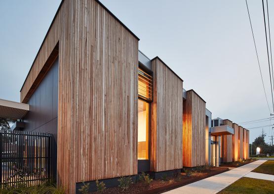 a row of houses with wood siding