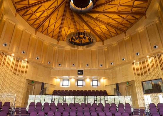 a room with purple chairs and a glass railing