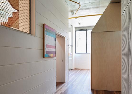 a hallway with a wood floor and a door