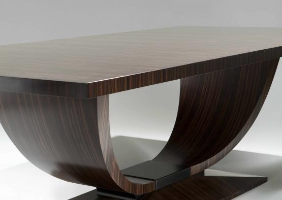 a wooden table with a curved base