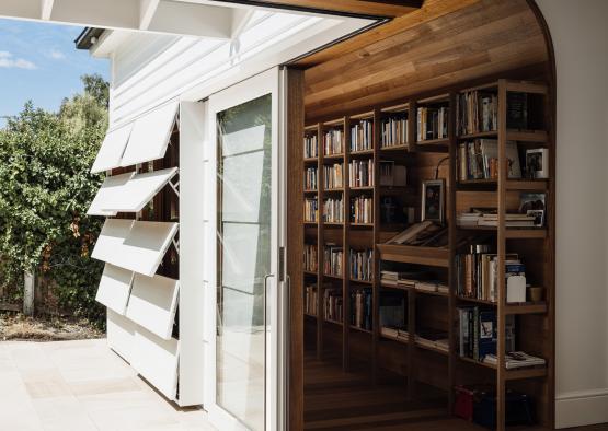 a room with a bookcase and a door open