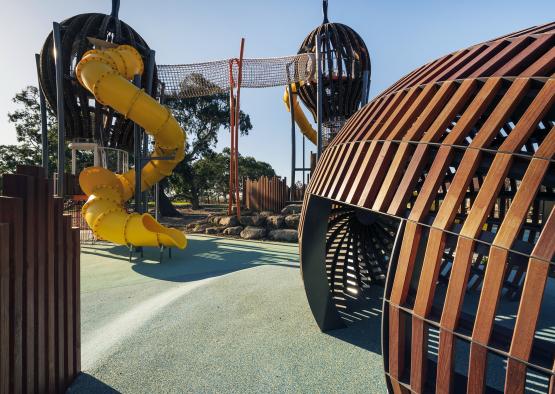 a playground with a slide and a net