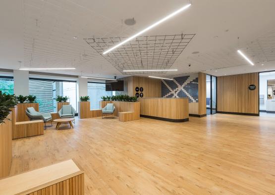 a room with a reception desk and chairs