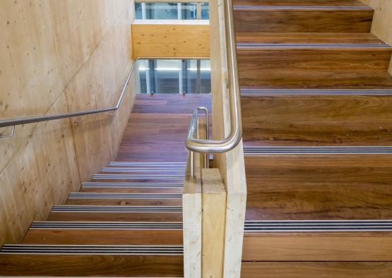 a wooden staircase with metal handrails