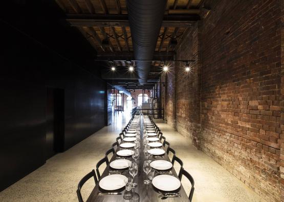 a long table with plates and glasses on it