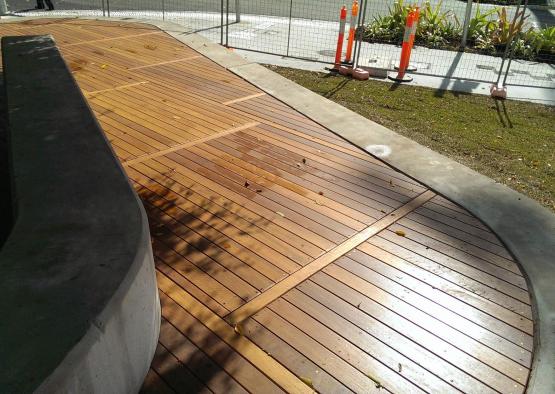 a wooden deck with orange cones and grass