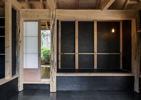 a room with a wood wall and a light bulb