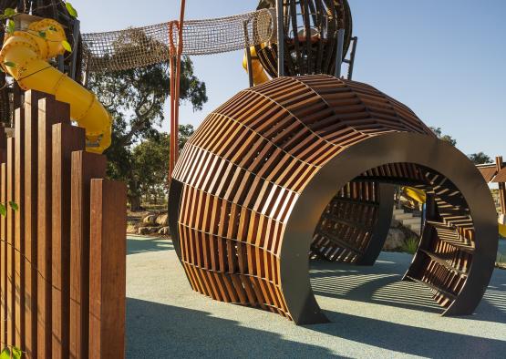 a playground with a tunnel and a slide