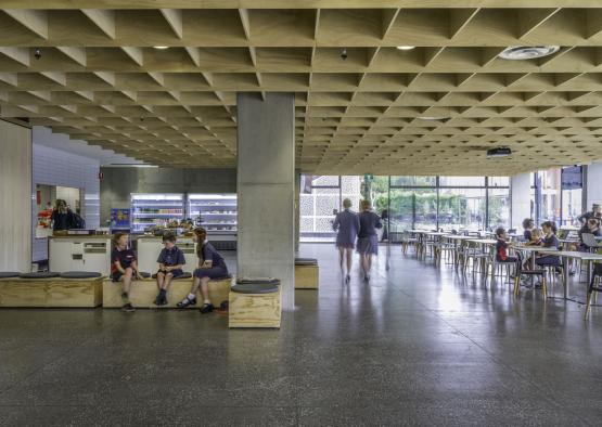 people in a room with a large ceiling and a group of people