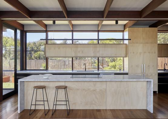 a kitchen with a bar and stools