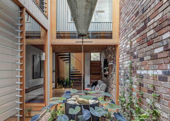 a courtyard with a stone fountain and plants