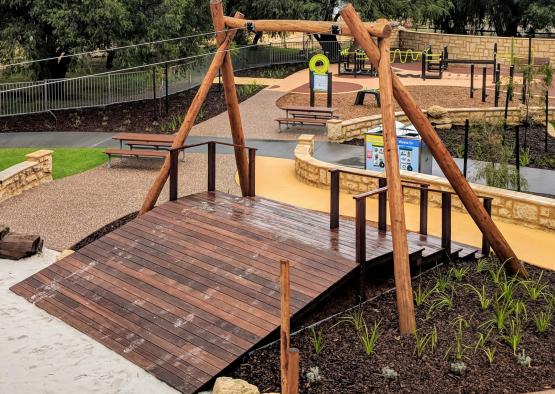 a wooden bridge in a park