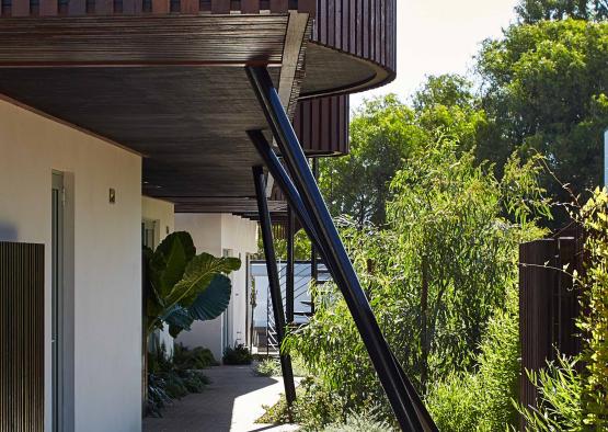 a building with a balcony and trees