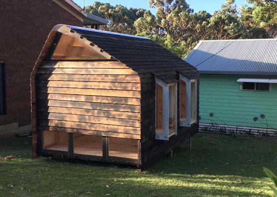 a small wooden house in a yard