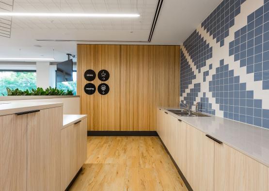 a room with wood cabinets and a blue and white wall