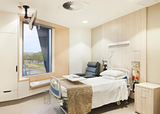 a hospital room with a bed and a chair