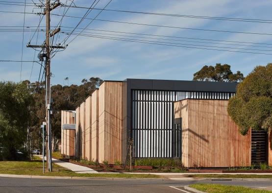 a building with a fence and power lines