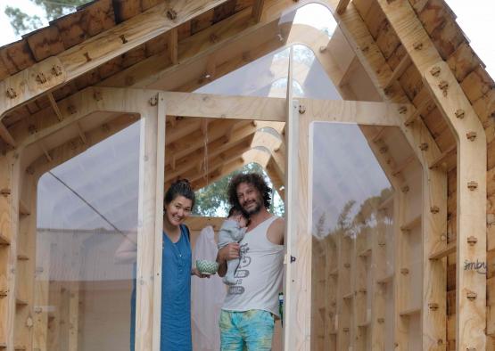 a man and woman standing in a wooden house