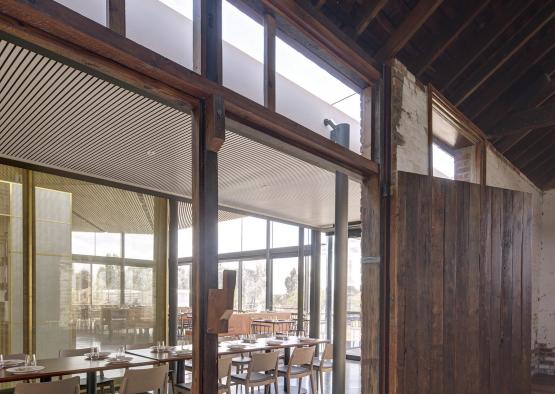 a room with a large wooden wall and a table with chairs