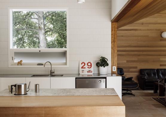 a kitchen with a wood countertop and a couch